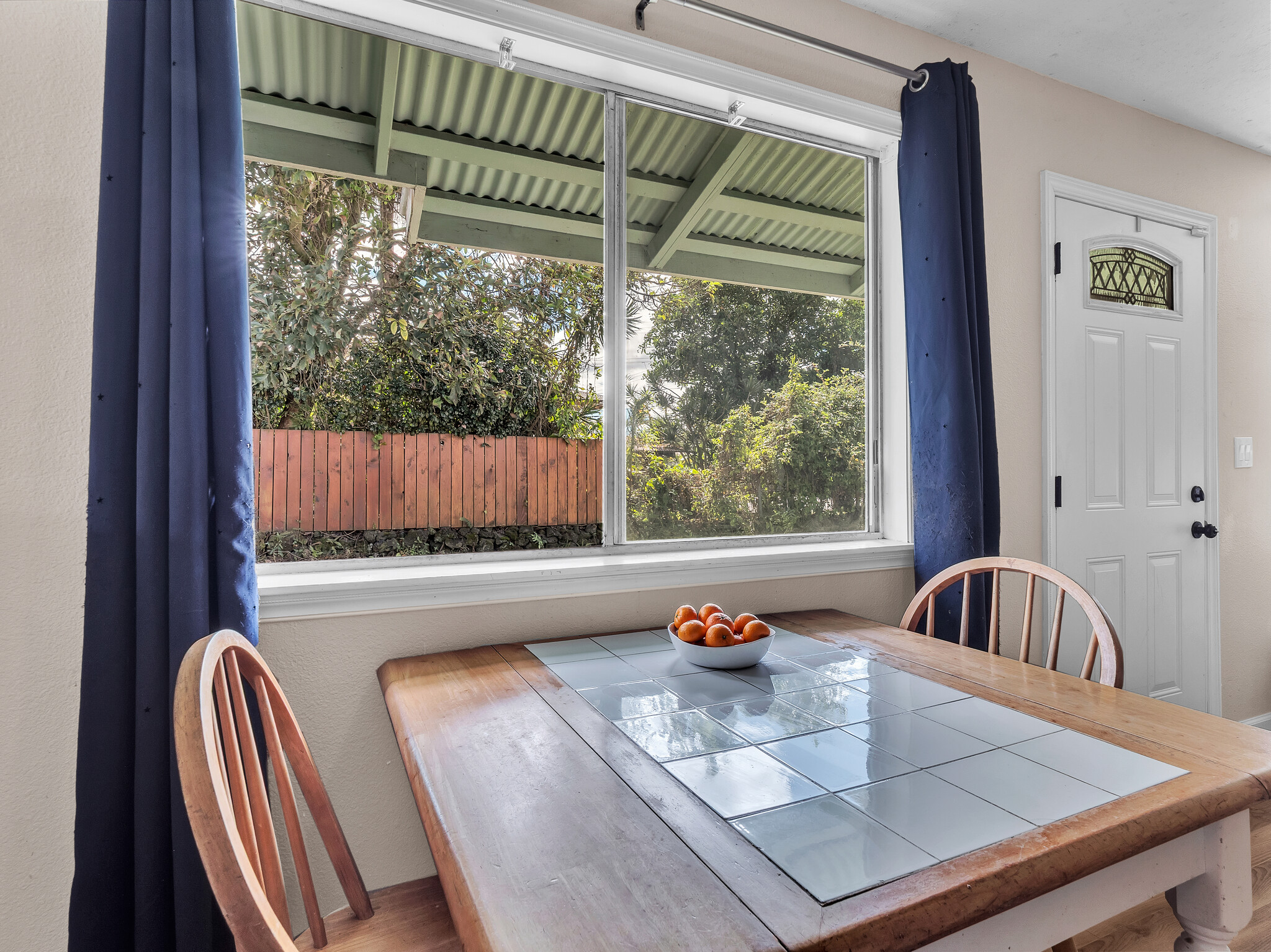 17-7658 North Kulani Road Mountain View, HI 96771 - Photo 14 of 24 a view of a dining table and chairs in the balcony
