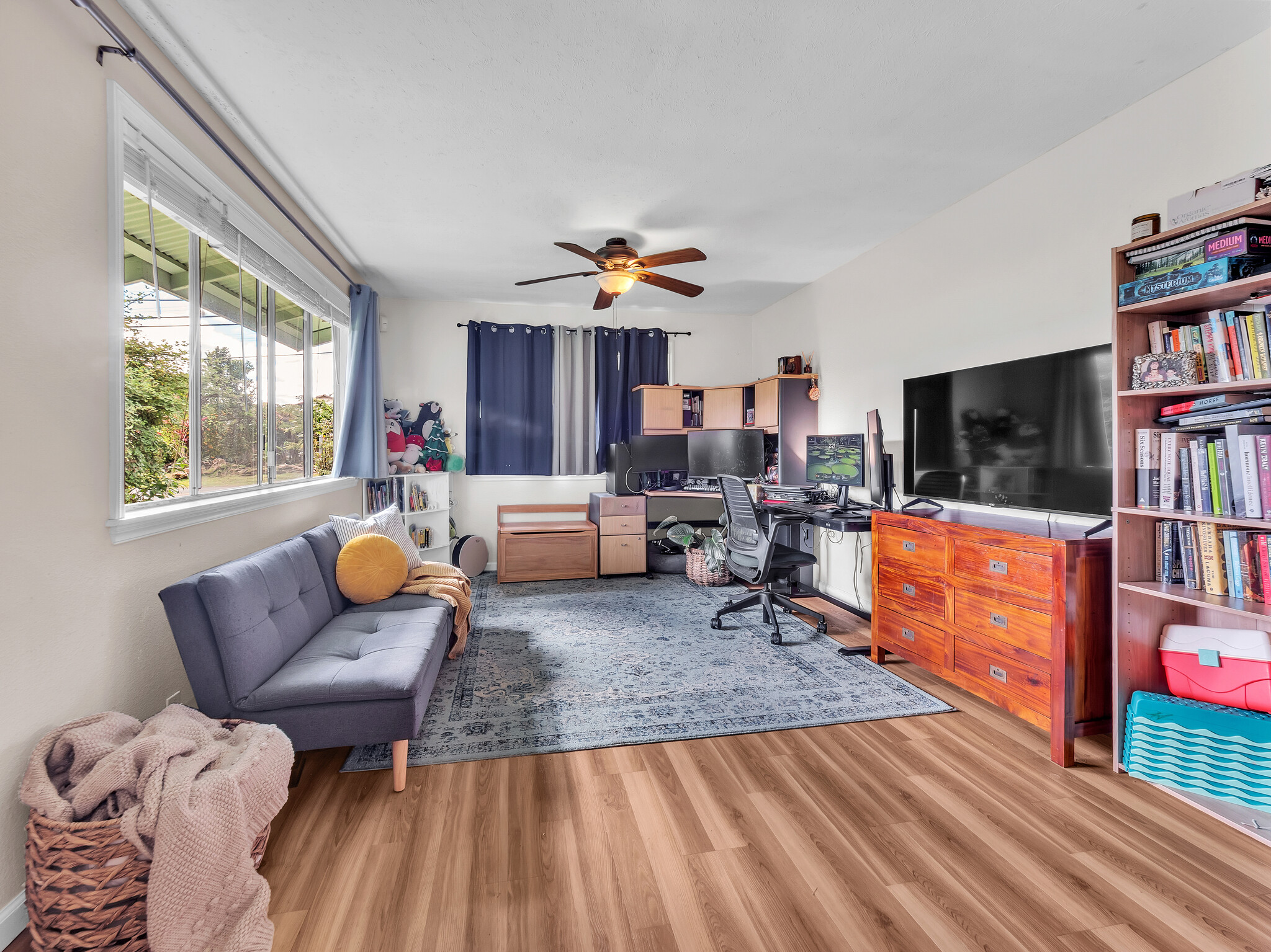 17-7658 North Kulani Road Mountain View, HI 96771 - Photo 16 of 24 a living room with furniture and a flat screen tv