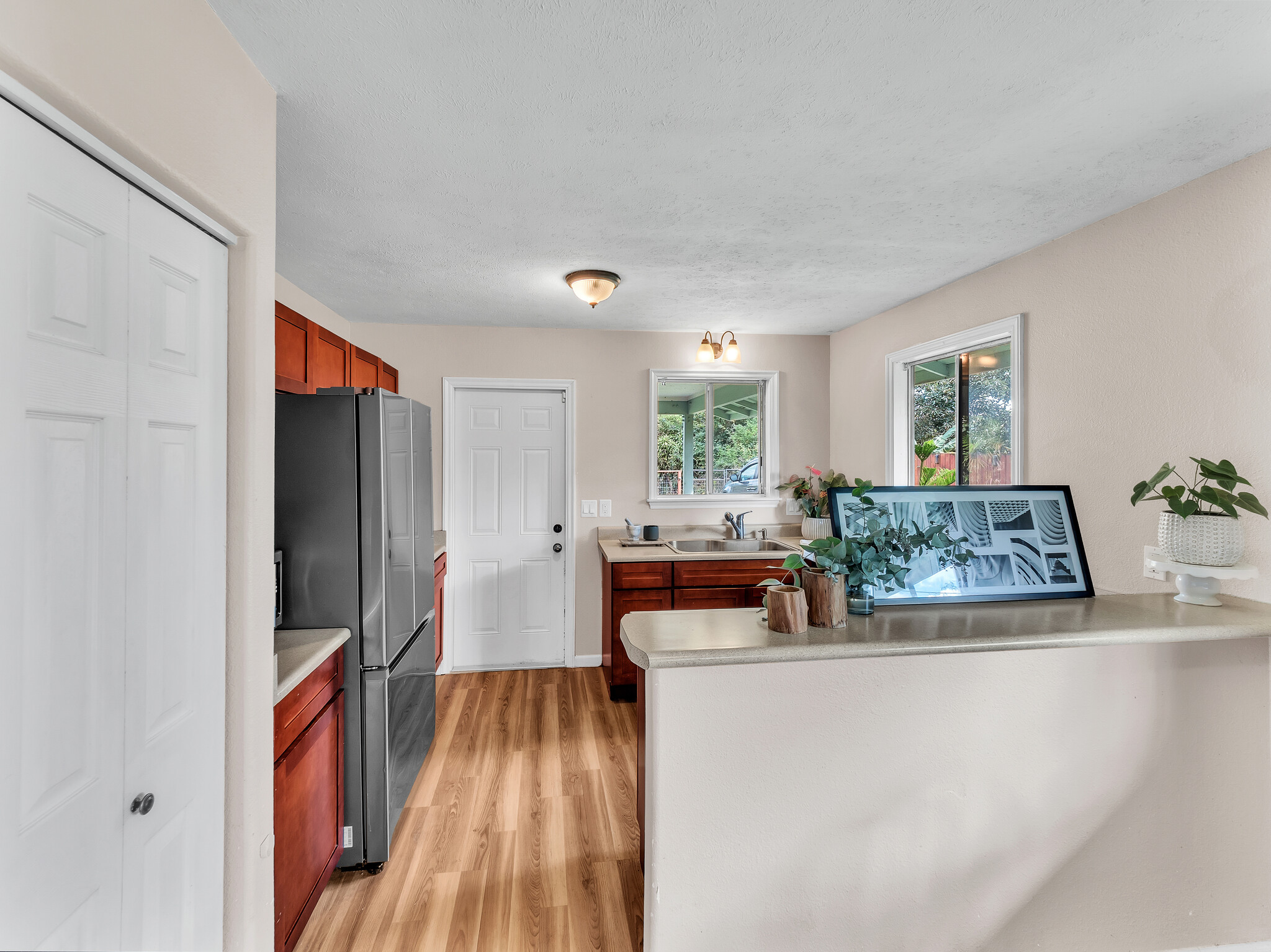 17-7658 North Kulani Road Mountain View, HI 96771 - Photo 17 of 24 a view of living room kitchen with furniture and wooden floor