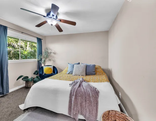 a bed sitting in a bedroom next to a window