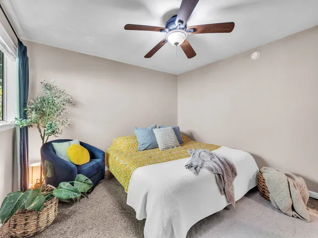 a bedroom with a bed mirror and on the wall