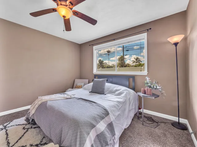 a bedroom with a bed and a painting on the wall
