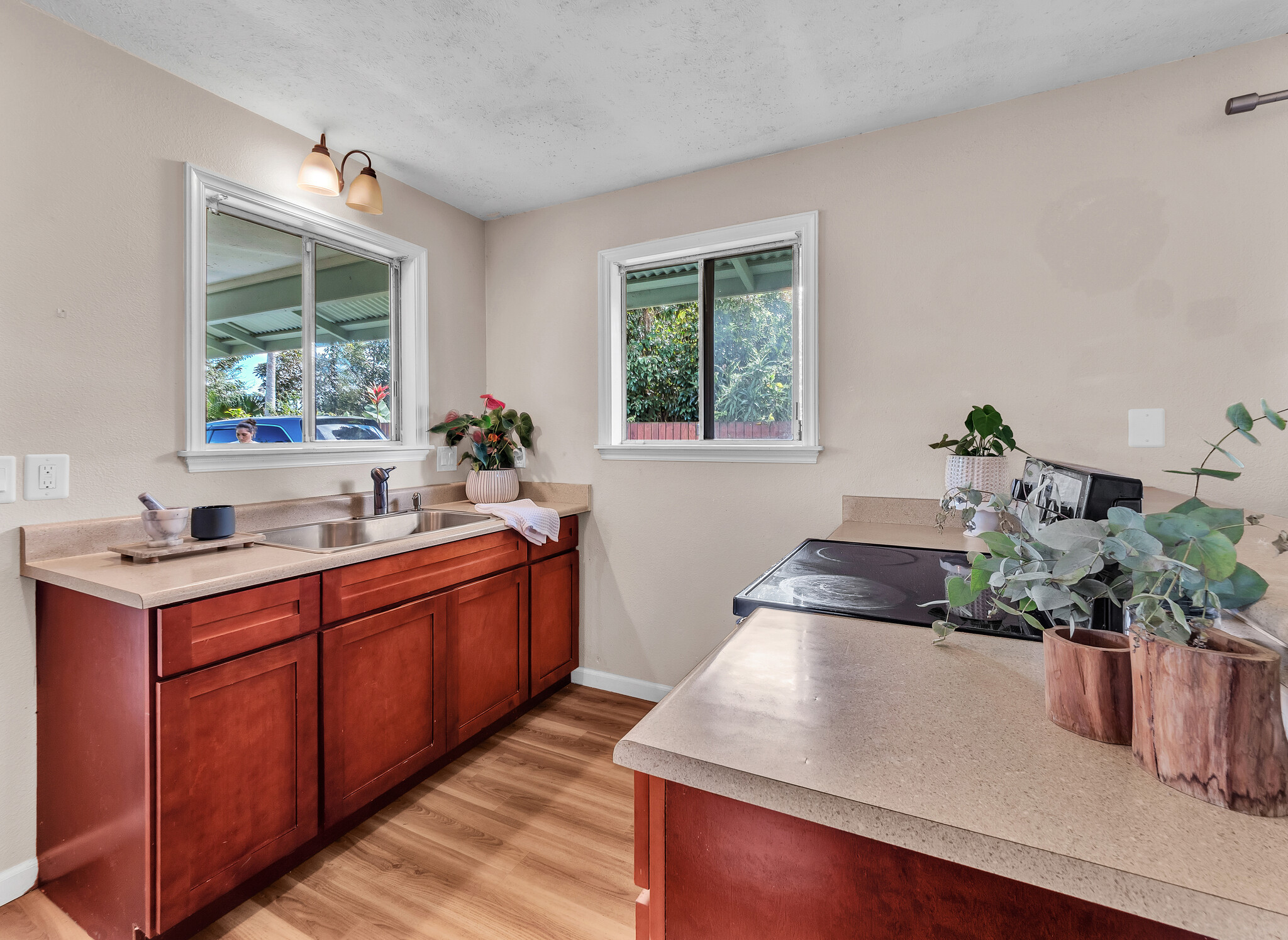 17-7658 North Kulani Road Mountain View, HI 96771 - Photo 9 of 24 a kitchen with stainless steel appliances granite countertop a sink a stove and a wooden floors