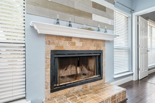 a room with fireplace and a wooden floor