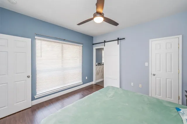 an empty room with windows and closet