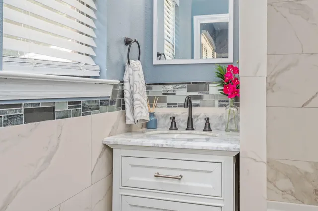 a bathroom with a sink vanity and a mirror