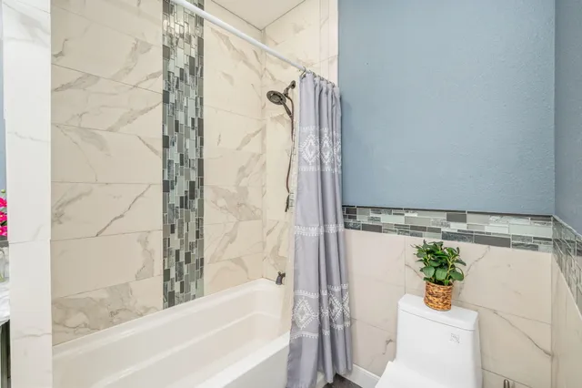 a bathroom with a shower and a tub