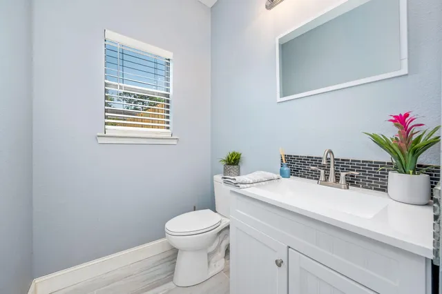 a bathroom with a sink a toilet and a mirror