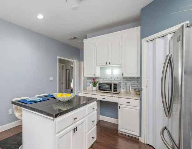 a kitchen with stainless steel appliances a sink and a refrigerator
