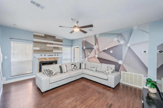 a living room with furniture and wooden floor