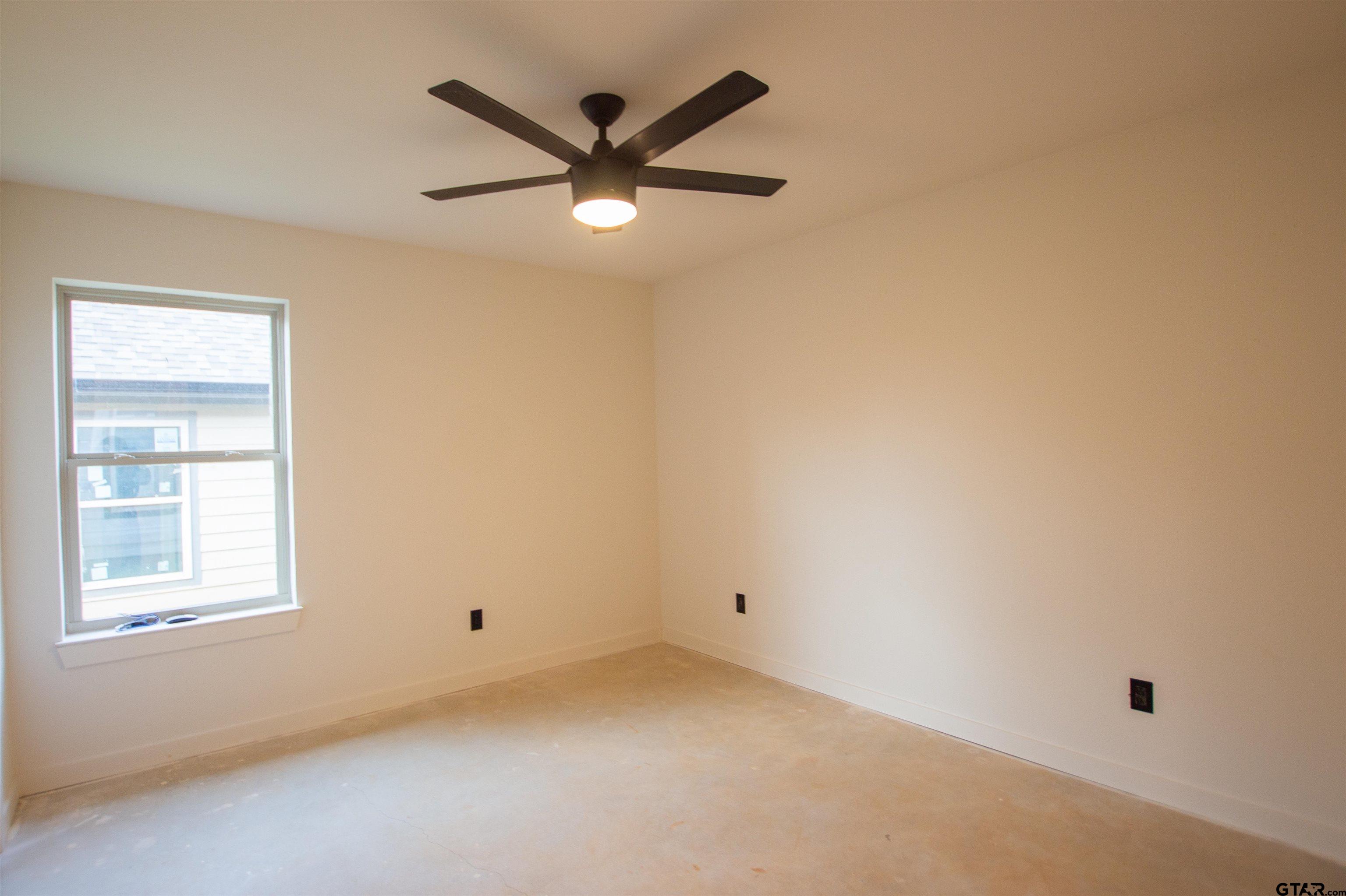 1112 Park Street Tyler, TX 75702 - Photo 11 of 26 an empty room with a window and a fan