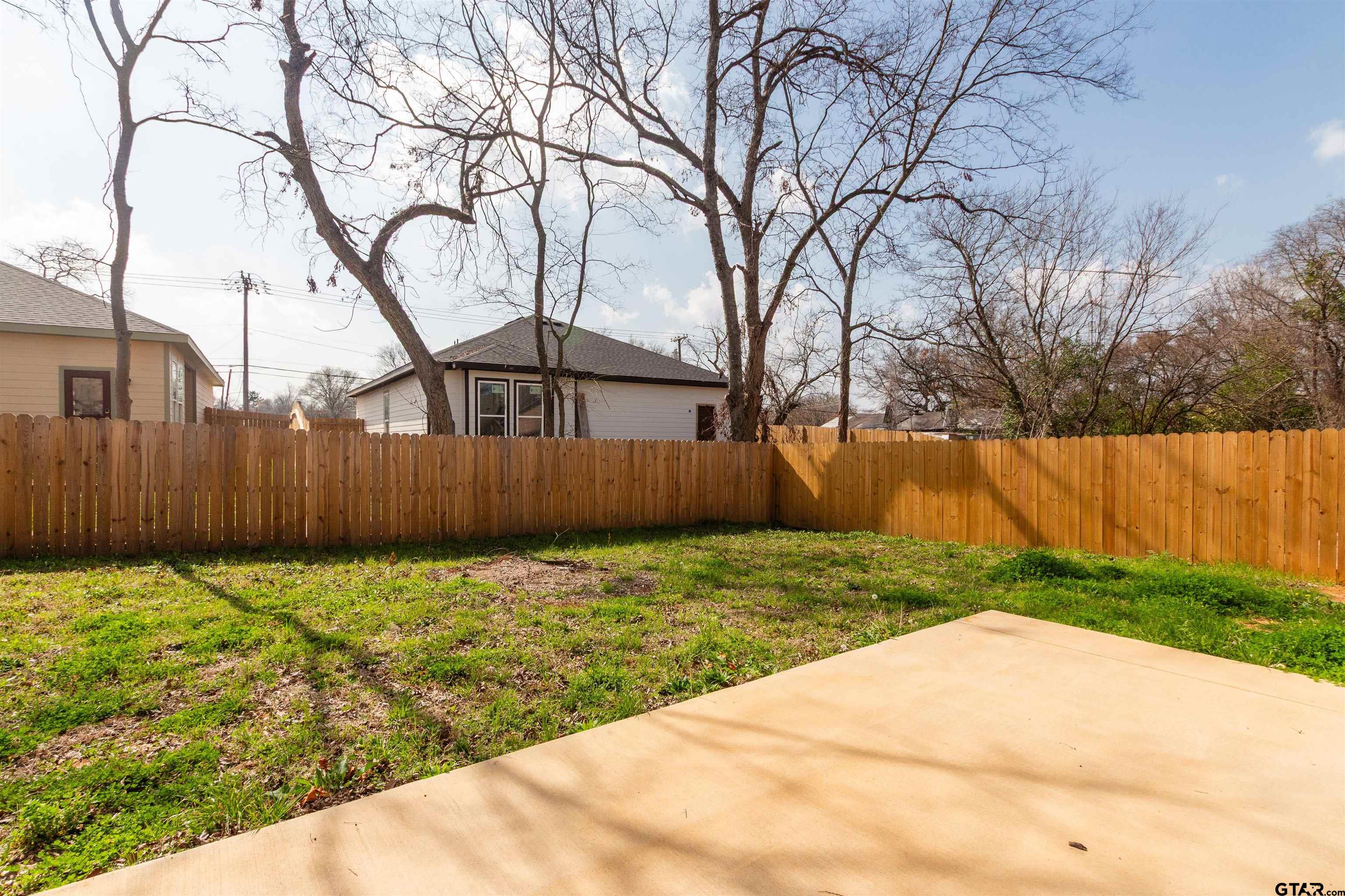 1112 Park Street Tyler, TX 75702 - Photo 25 of 26 a backyard of house with trees