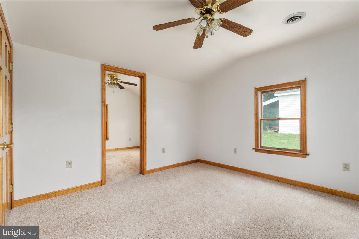 709 Dicks Hollow Road Winchester, VA 22603 - Photo 13 of 45 an empty room with a window and a ceiling fan
