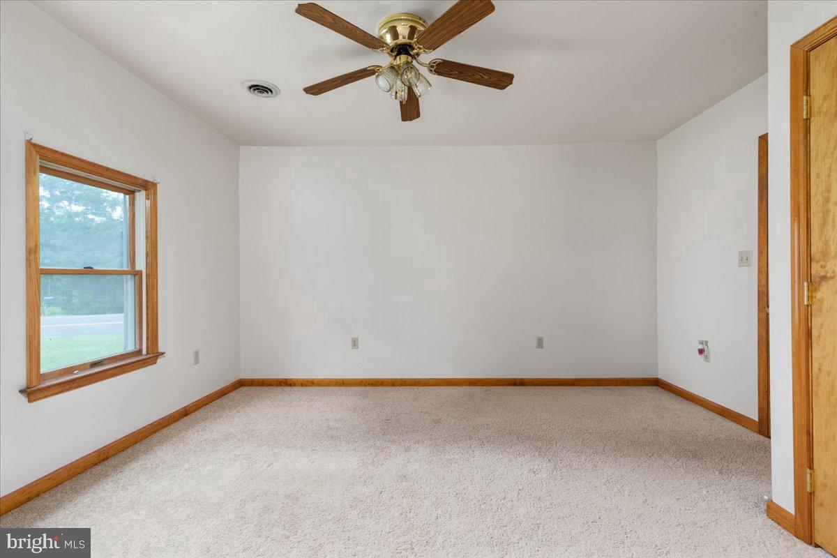 709 Dicks Hollow Road Winchester, VA 22603 - Photo 14 of 45 an empty room with a window and a fan
