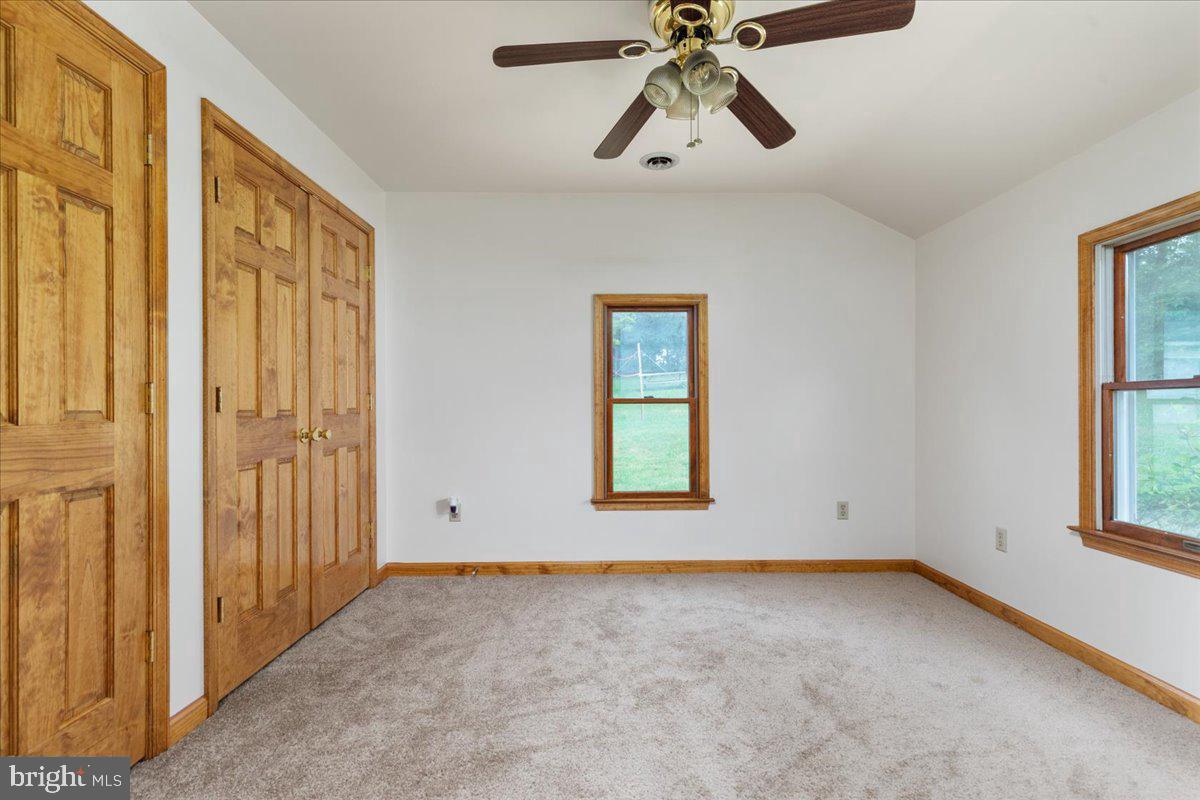 709 Dicks Hollow Road Winchester, VA 22603 - Photo 19 of 45 an empty room with windows and fan