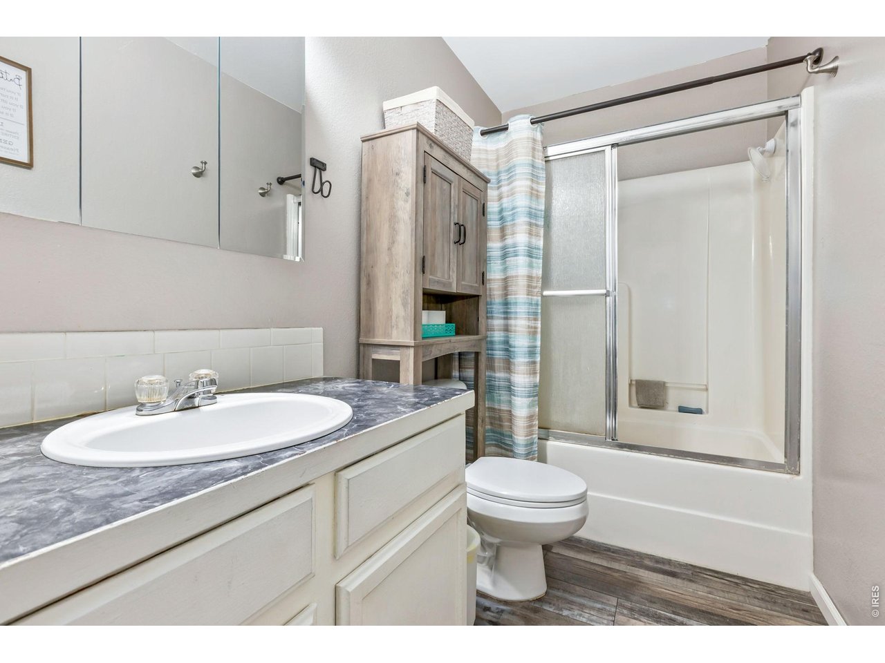 233 East 19th Street Road Greeley, CO 80631 - Photo 11 of 22 a bathroom with a sink toilet and shower