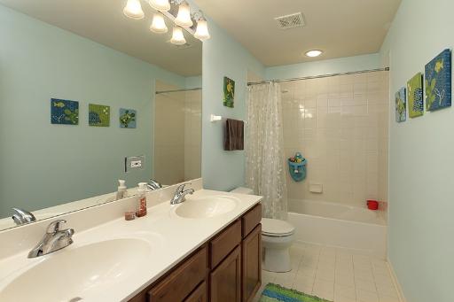800 De Roo Loop Highwood, IL 60040 - Photo 12 of 16 a bathroom with a sink a toilet and shower