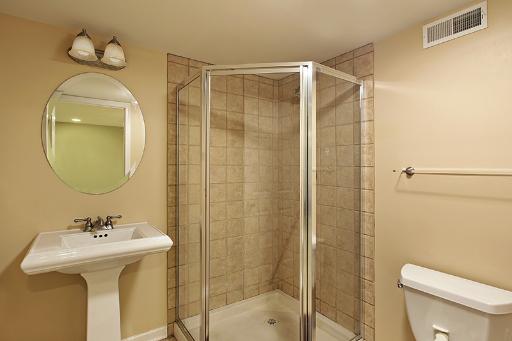 800 De Roo Loop Highwood, IL 60040 - Photo 14 of 16 a bathroom with a sink mirror toilet and shower