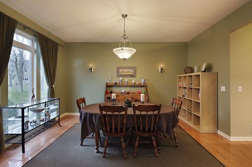 800 De Roo Loop Highwood, IL 60040 - Photo 3 of 16 a view of a dining room with furniture window and wooden floor