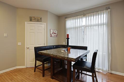 800 De Roo Loop Highwood, IL 60040 - Photo 6 of 16 a view of a dining room with furniture and wooden floor