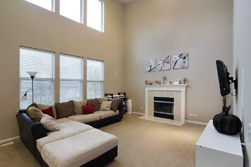 800 De Roo Loop Highwood, IL 60040 - Photo 8 of 16 a living room with furniture and a fireplace