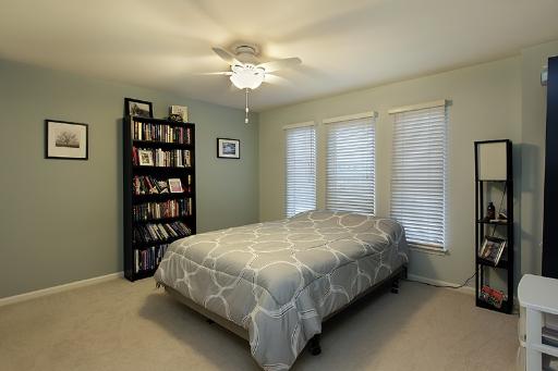 800 De Roo Loop Highwood, IL 60040 - Photo 9 of 16 a bedroom with a bed and a chandelier