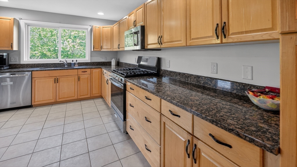 5 Governors Way, Unit B Milford, MA 01757 - Photo 21 of 42 a kitchen with a sink dishwasher and cabinets