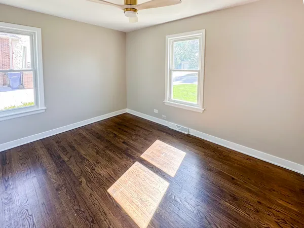 wooden floor in an empty room with a window