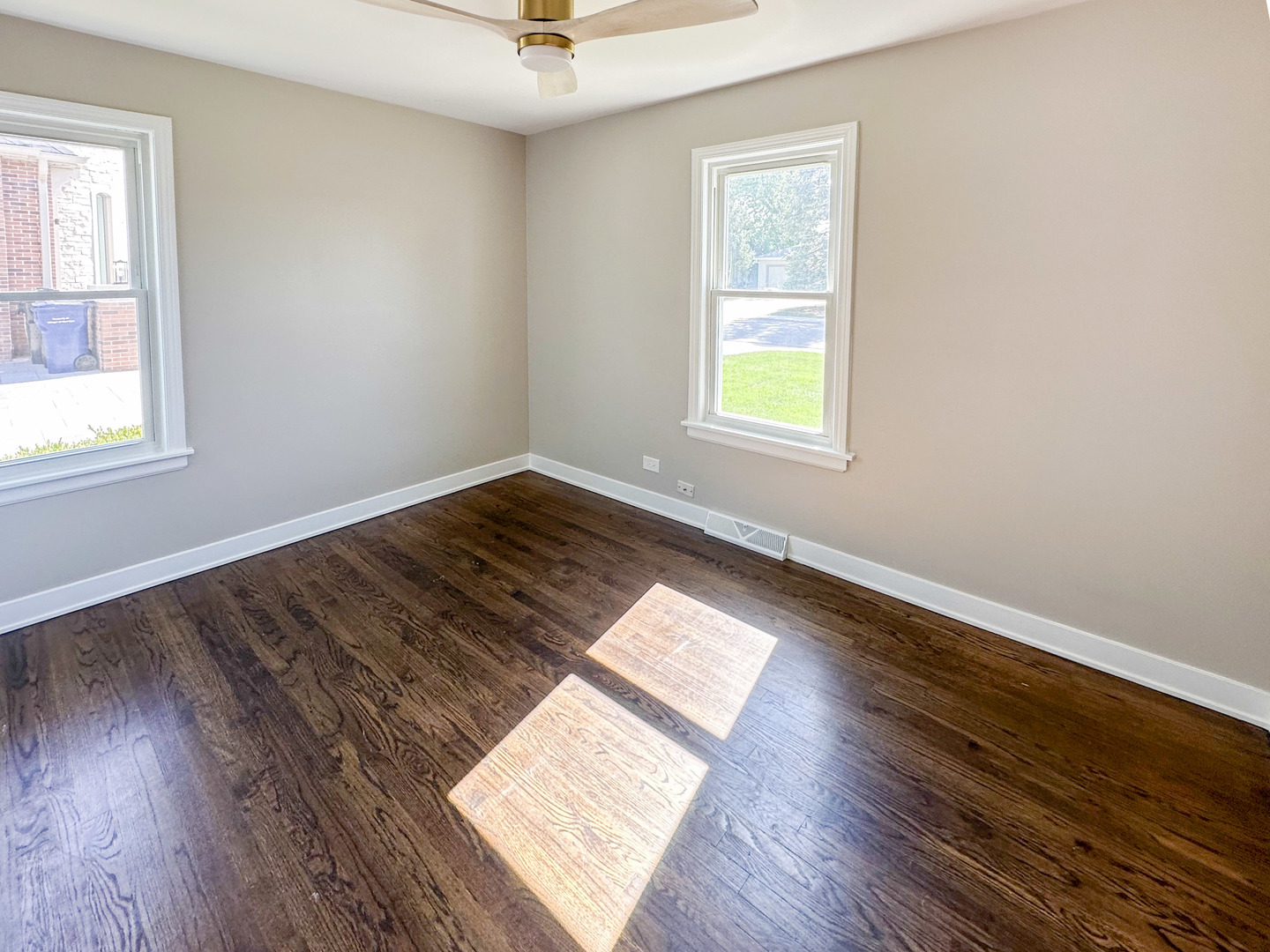 8150 West Winnemac Avenue Norridge, IL 60706 - Photo 11 of 14 wooden floor in an empty room with a window