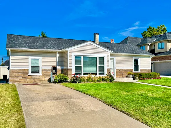 a front view of a house with a yard and porch