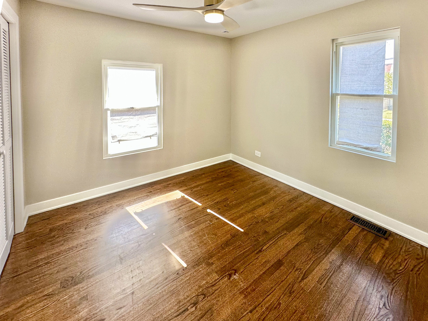 8150 West Winnemac Avenue Norridge, IL 60706 - Photo 9 of 14 an empty room with wooden floor and windows