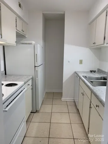 a kitchen with a stove top oven and cabinets