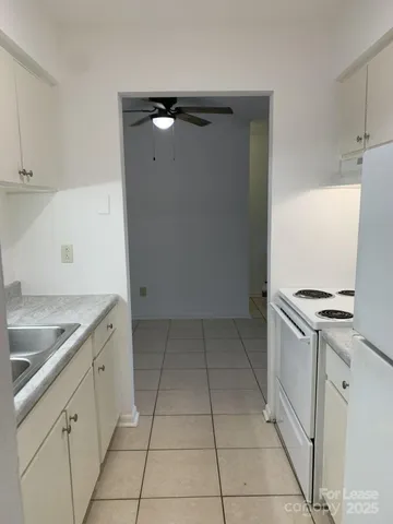 a kitchen with granite countertop a sink and a stove