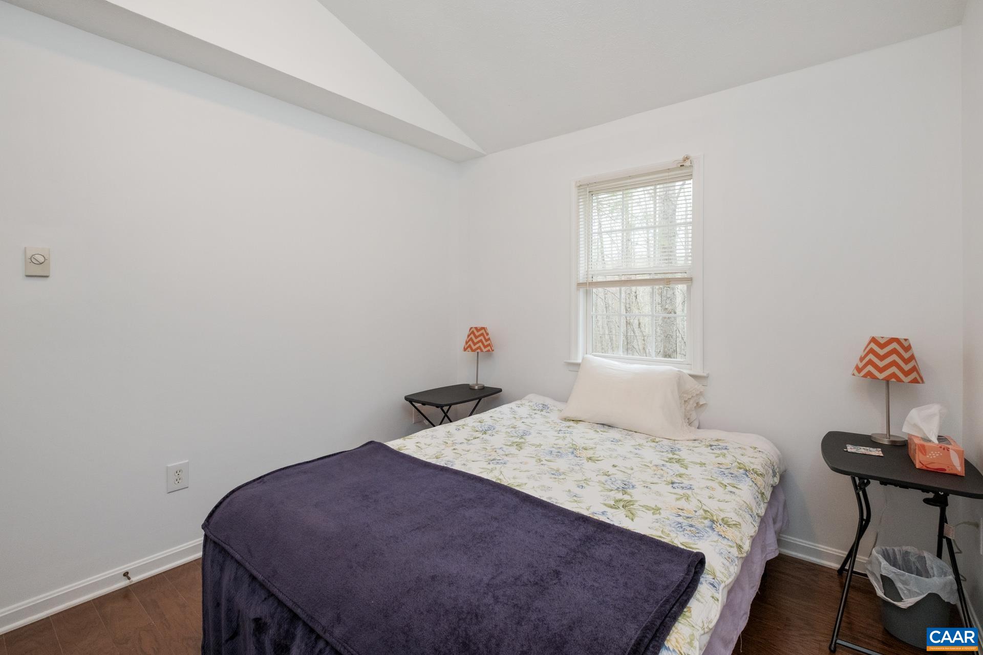 115 Circle Road Stanardsville, VA 22973 - Photo 17 of 28 a bedroom with a bed and a table in it