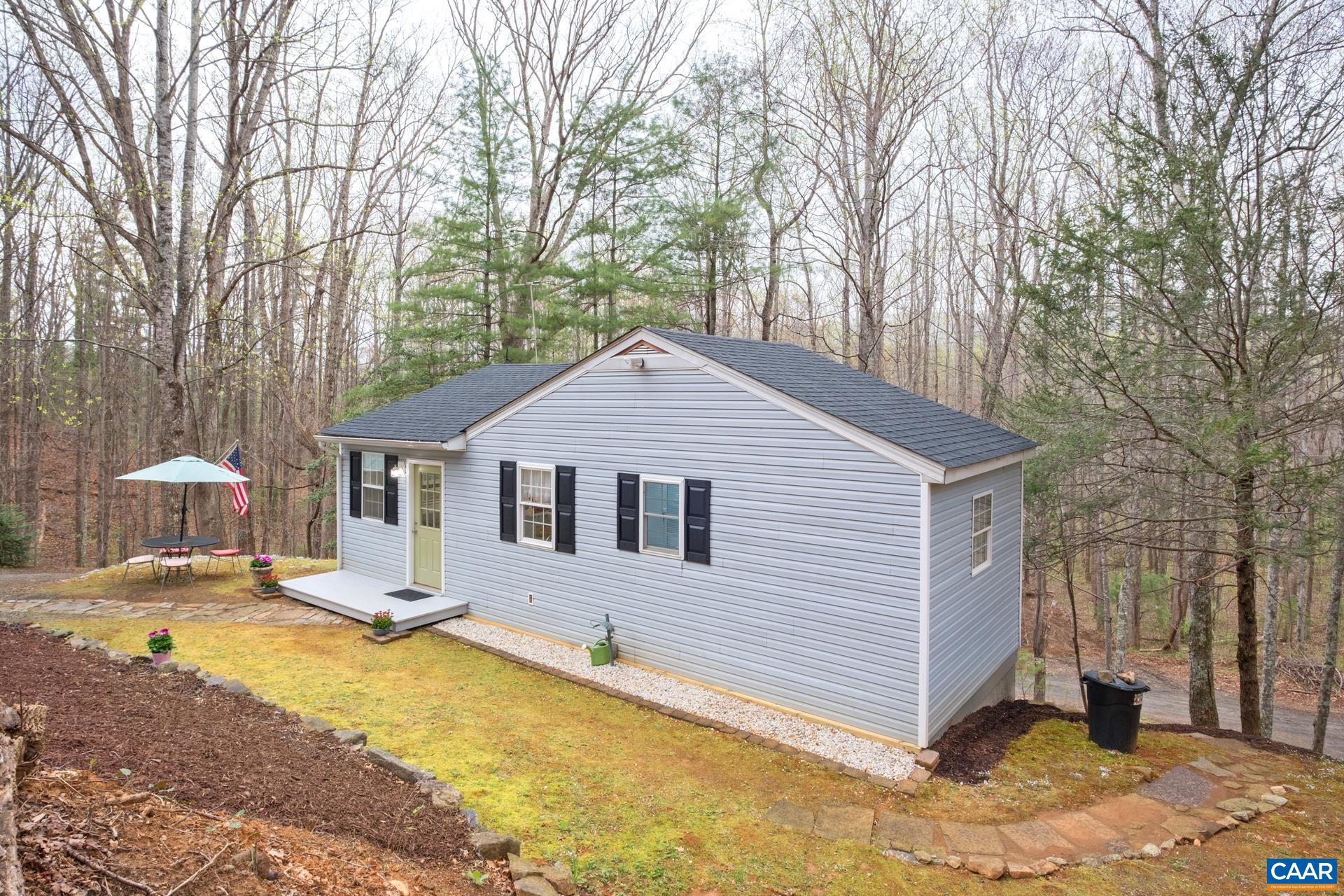 115 Circle Road Stanardsville, VA 22973 - Photo 3 of 28 a front view of house with yard and trees in the background
