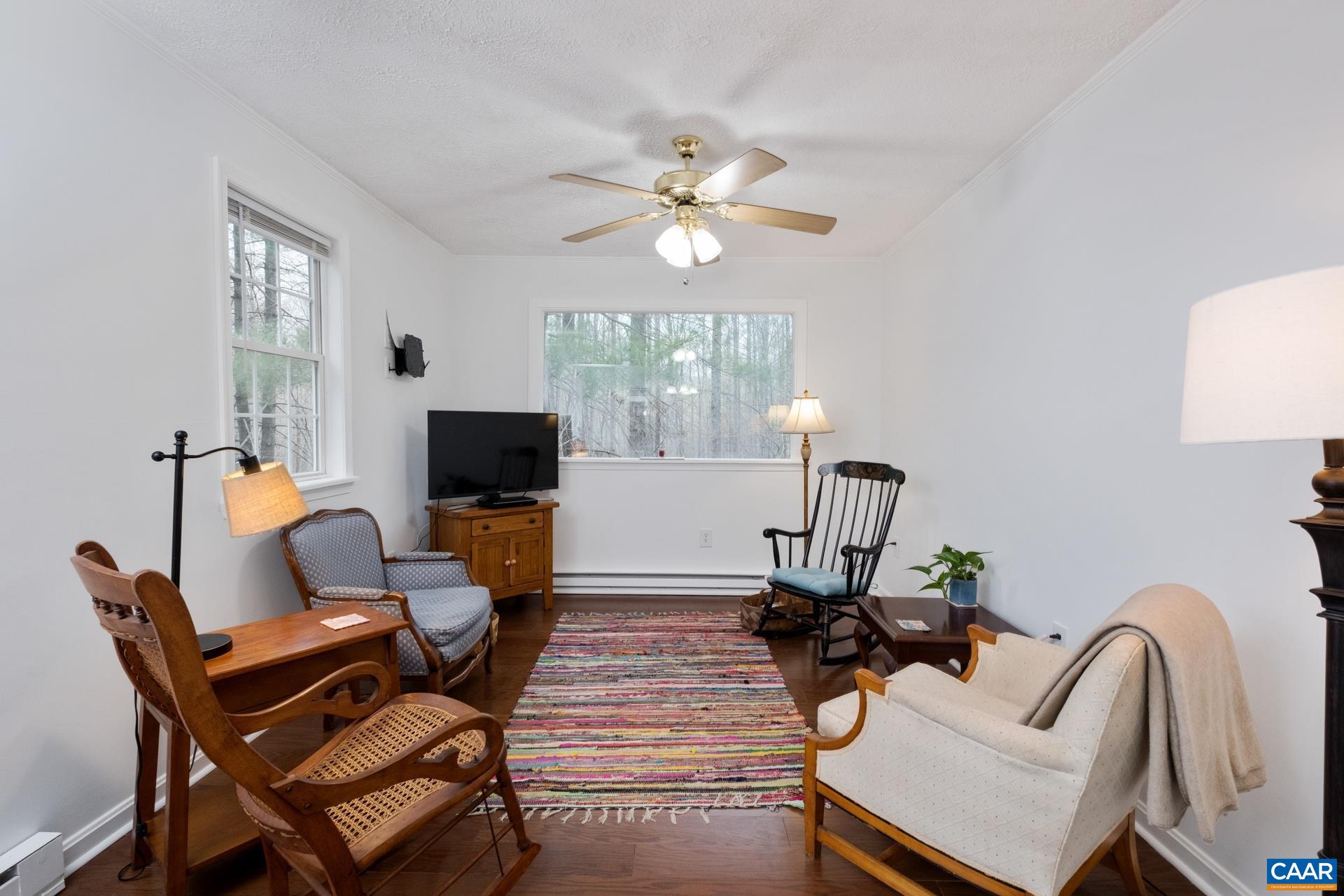 115 Circle Road Stanardsville, VA 22973 - Photo 7 of 28 a living room with furniture a fireplace and a flat screen tv