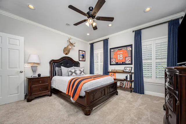 a front view of a house with a garden and swimming pool