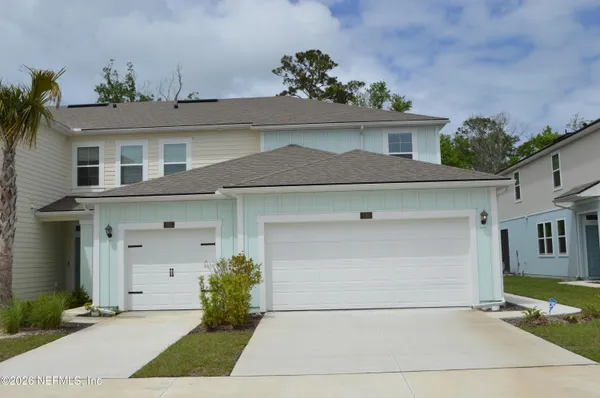 a front view of a house with garage