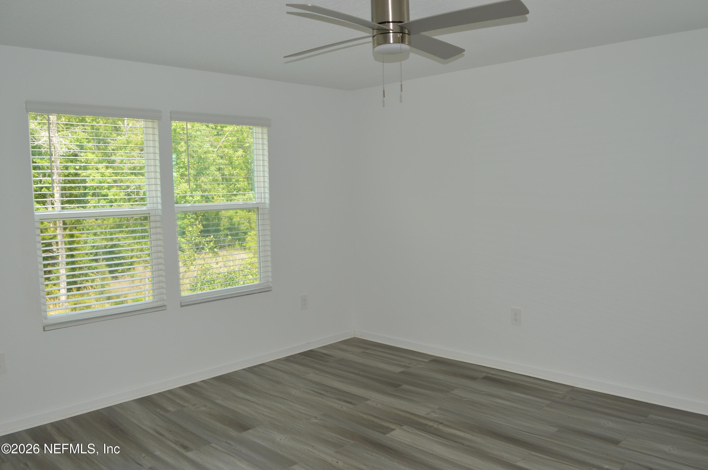 155 Seaport Breeze Road St. Augustine, FL 32095 - Photo 11 of 29 a view of an empty room with wooden floor and a window
