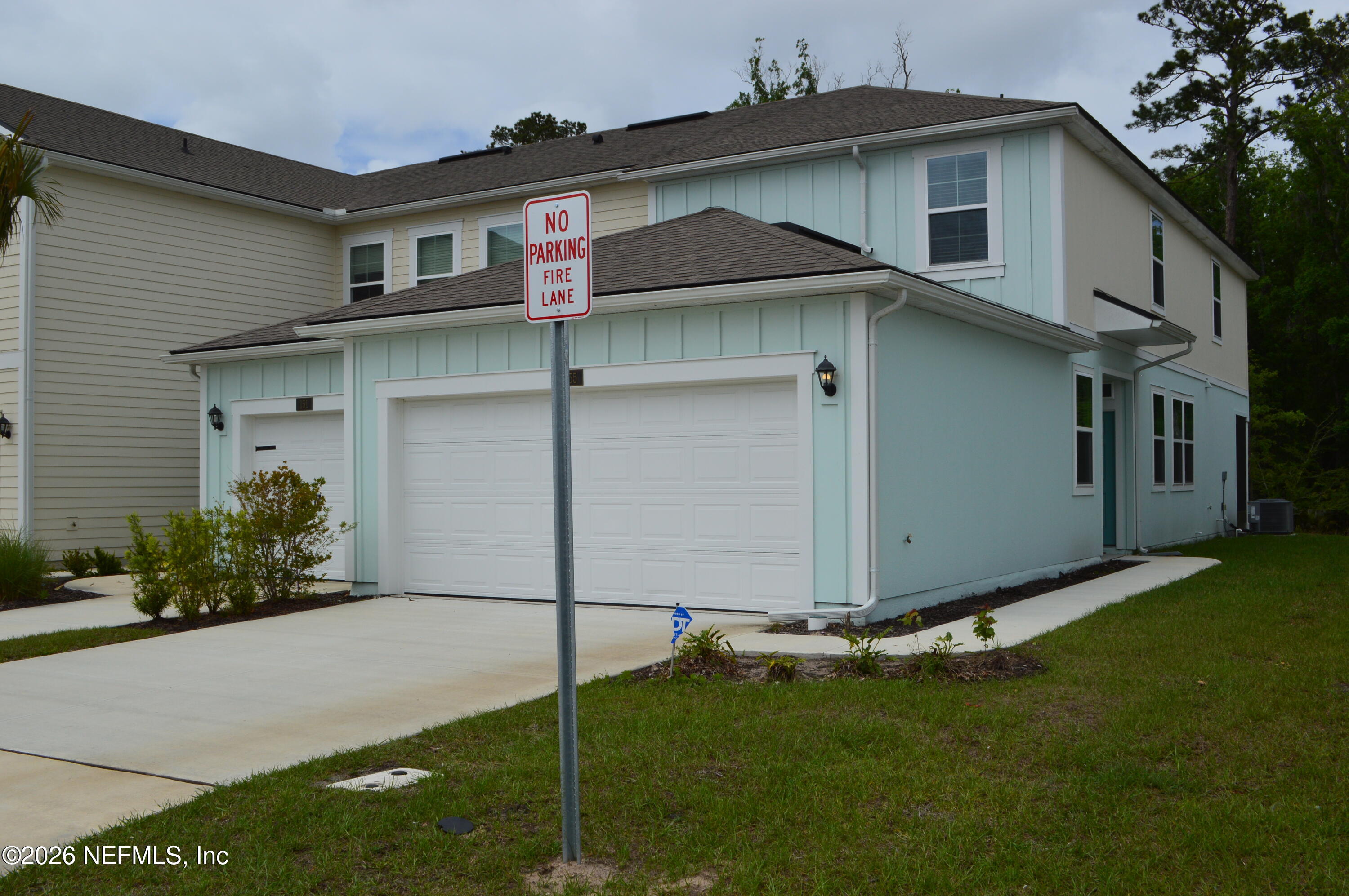 155 Seaport Breeze Road St. Augustine, FL 32095 - Photo 18 of 29 a front view of a house with garden