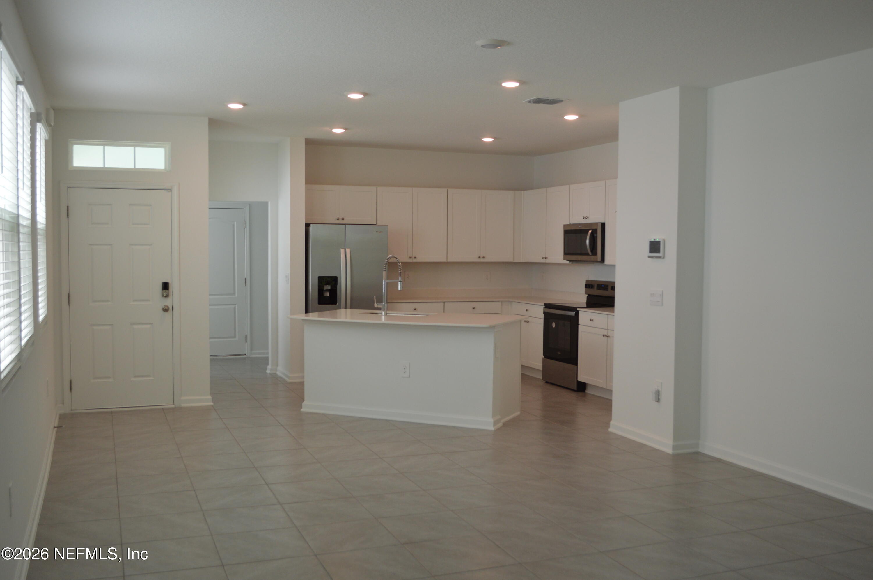 155 Seaport Breeze Road St. Augustine, FL 32095 - Photo 6 of 29 a large kitchen with a large window and stainless steel appliances
