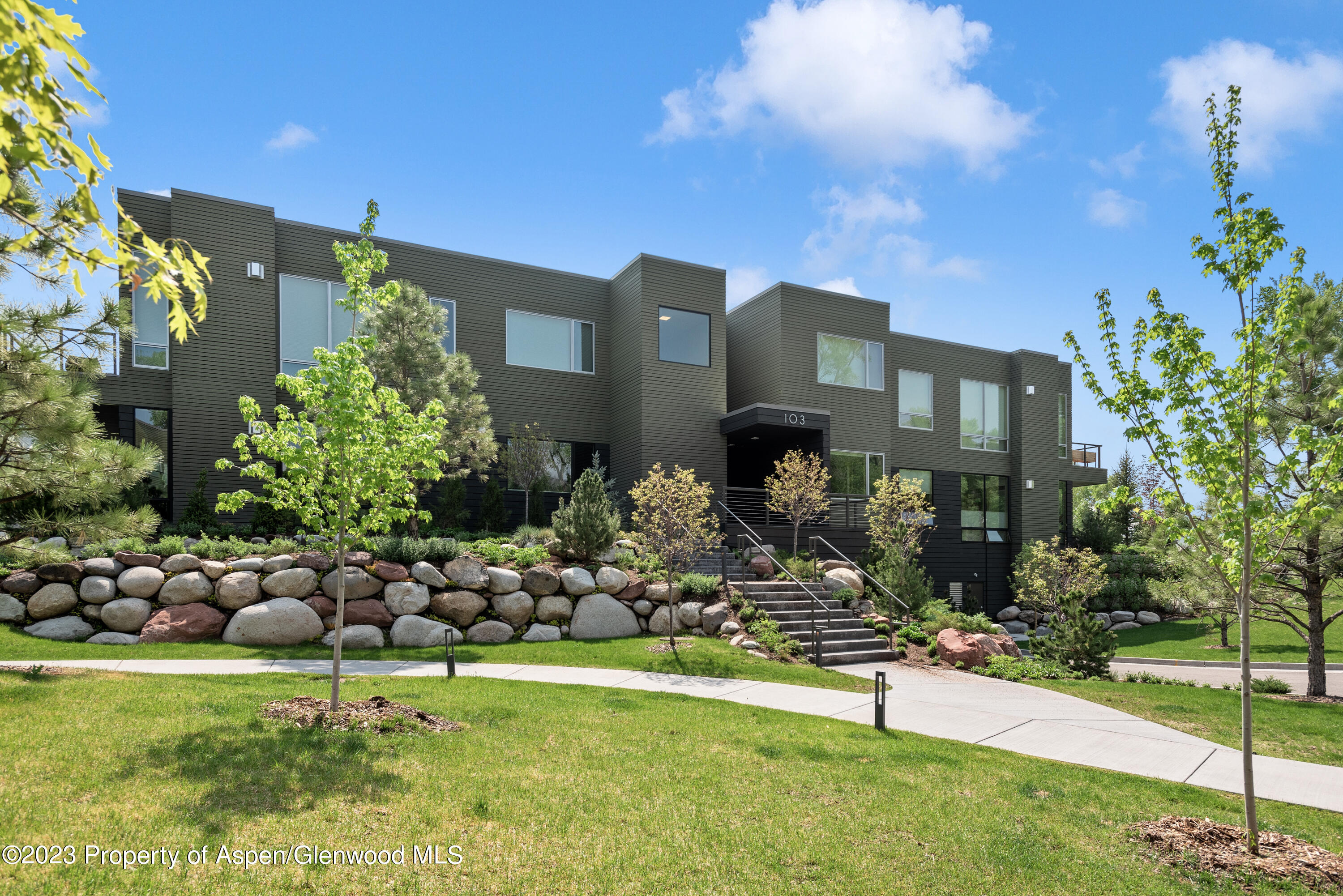 103 Willits Lane, Unit 203 Basalt, CO 81621 - Photo 13 of 17 a front view of a house with a yard and trees