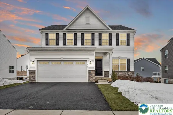 a front view of a house with a yard and garage