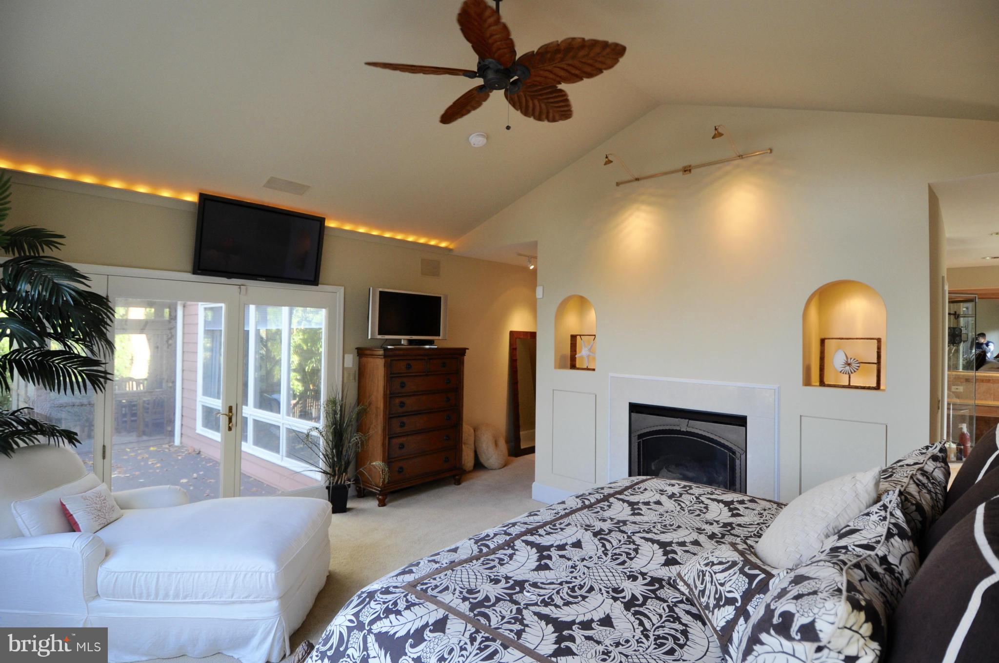 1890 Hidden Point Road Annapolis, MD 21409 - Photo 17 of 30 a bedroom with a bed and a fireplace