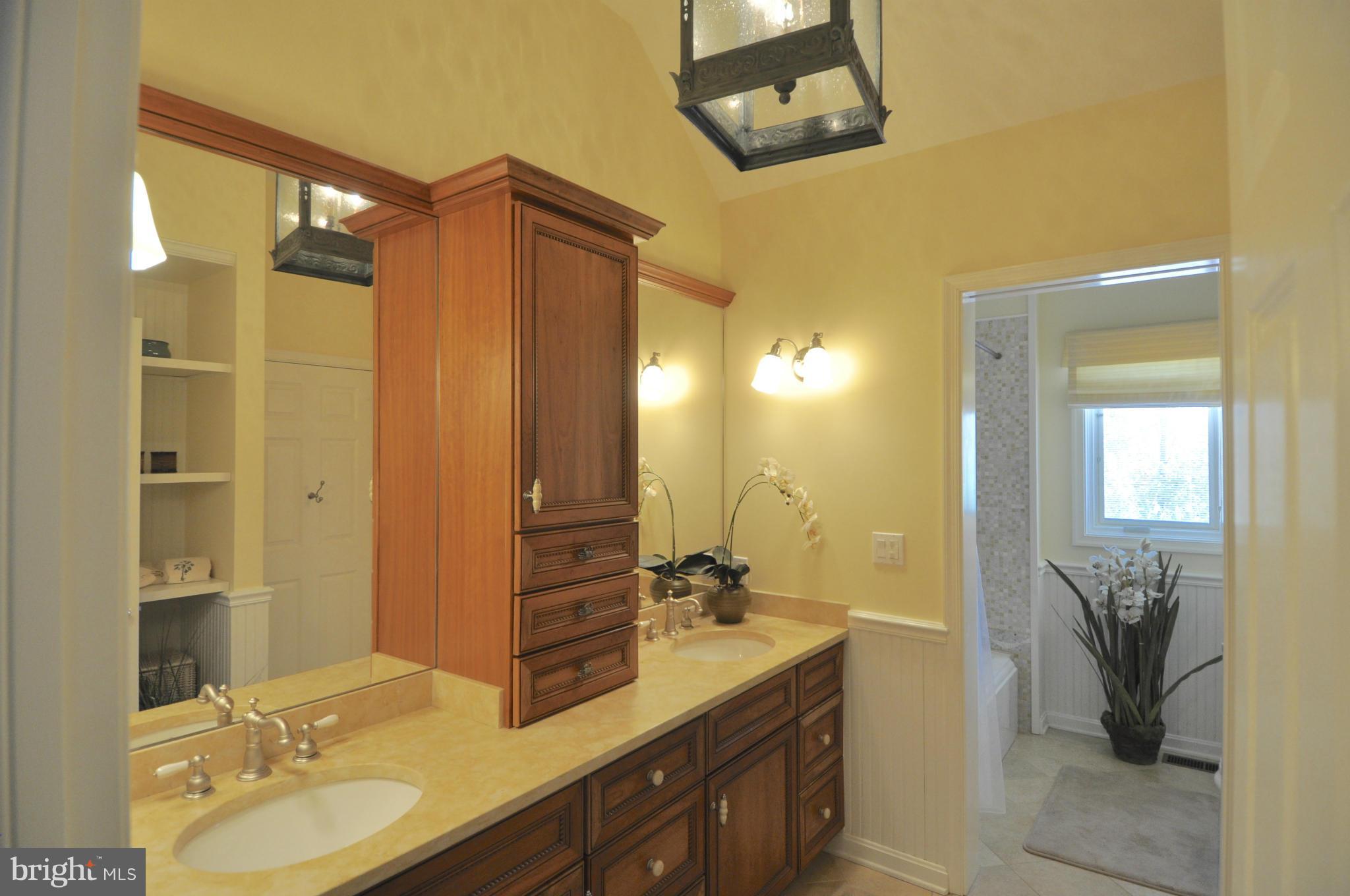 1890 Hidden Point Road Annapolis, MD 21409 - Photo 21 of 30 a bathroom with a double vanity sink mirror and shower
