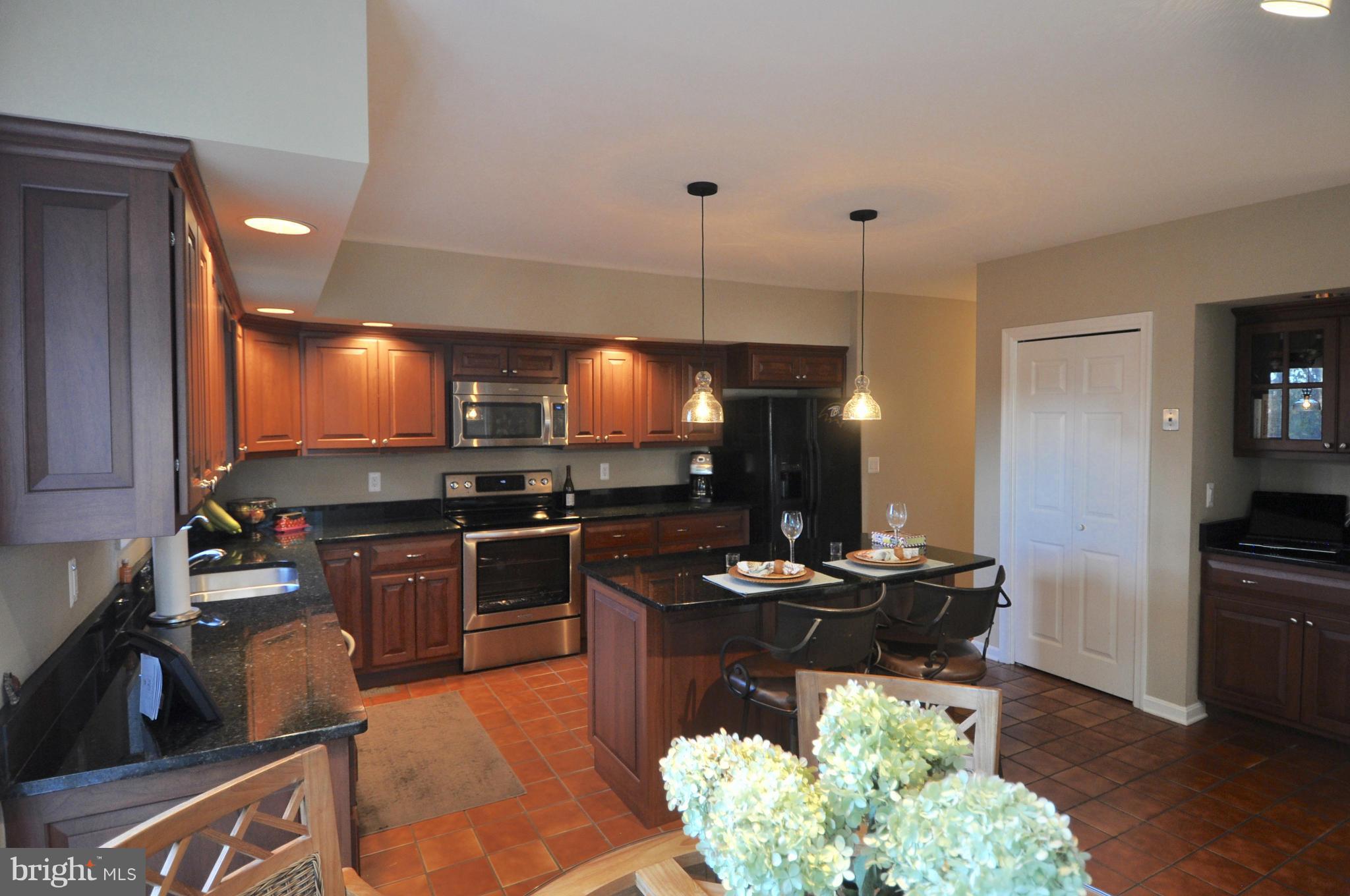 1890 Hidden Point Road Annapolis, MD 21409 - Photo 9 of 30 a kitchen with a stove and a refrigerator
