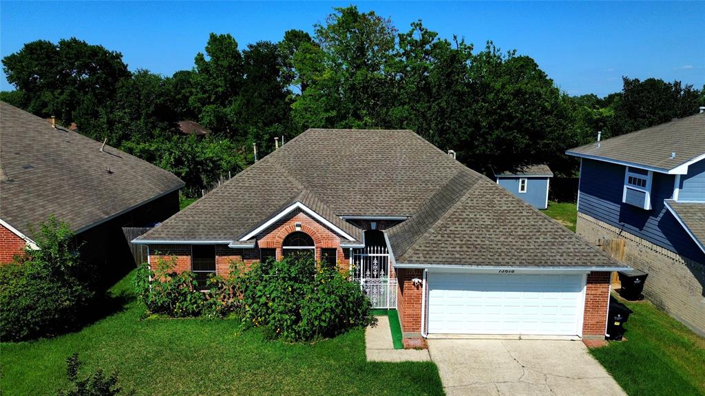 13618 Sablegrove Lane Houston, TX 77014 - Photo 3 of 30 a front view of a house with garden
