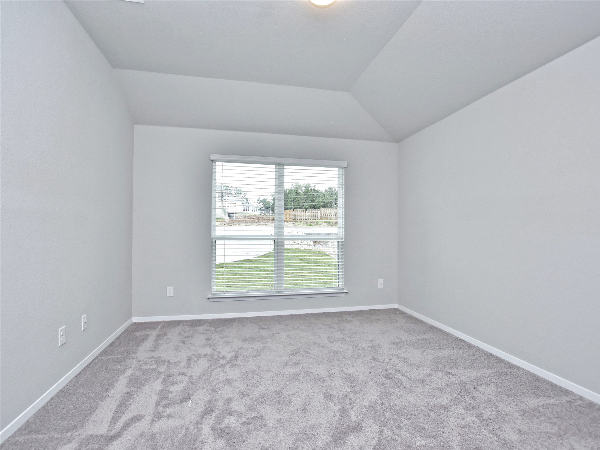 20701 Boggy Ford Road Lago Vista, TX 78645 - Photo 13 of 40 Empty room featuring light carpet and lofted ceiling