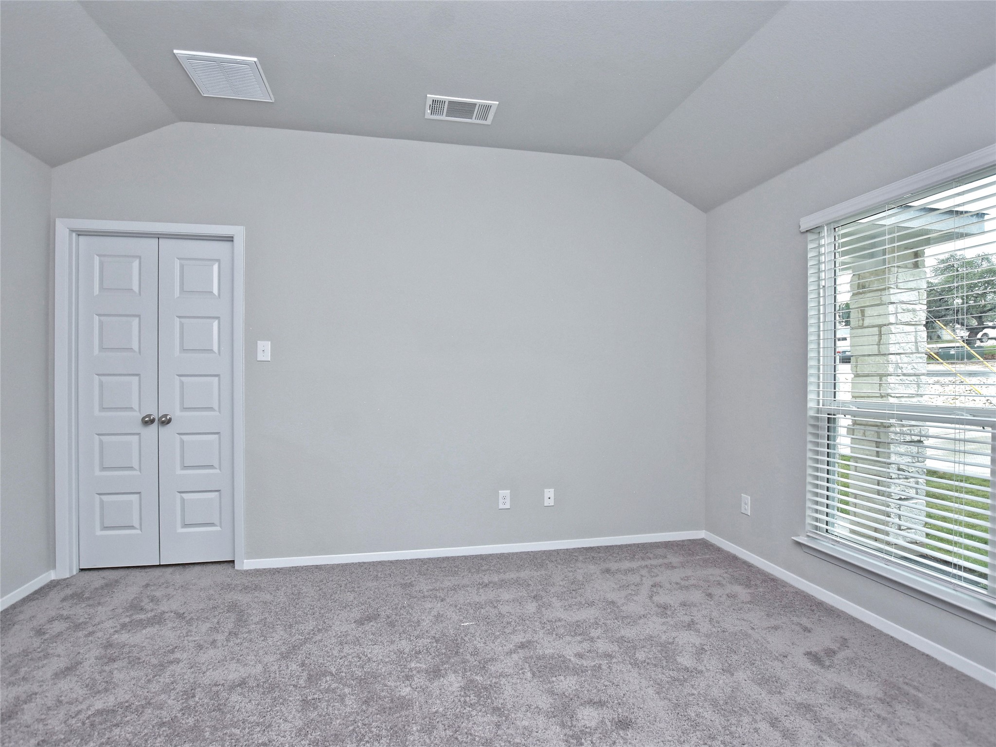 20701 Boggy Ford Road Lago Vista, TX 78645 - Photo 14 of 40 Spare room featuring vaulted ceiling and light colored carpet