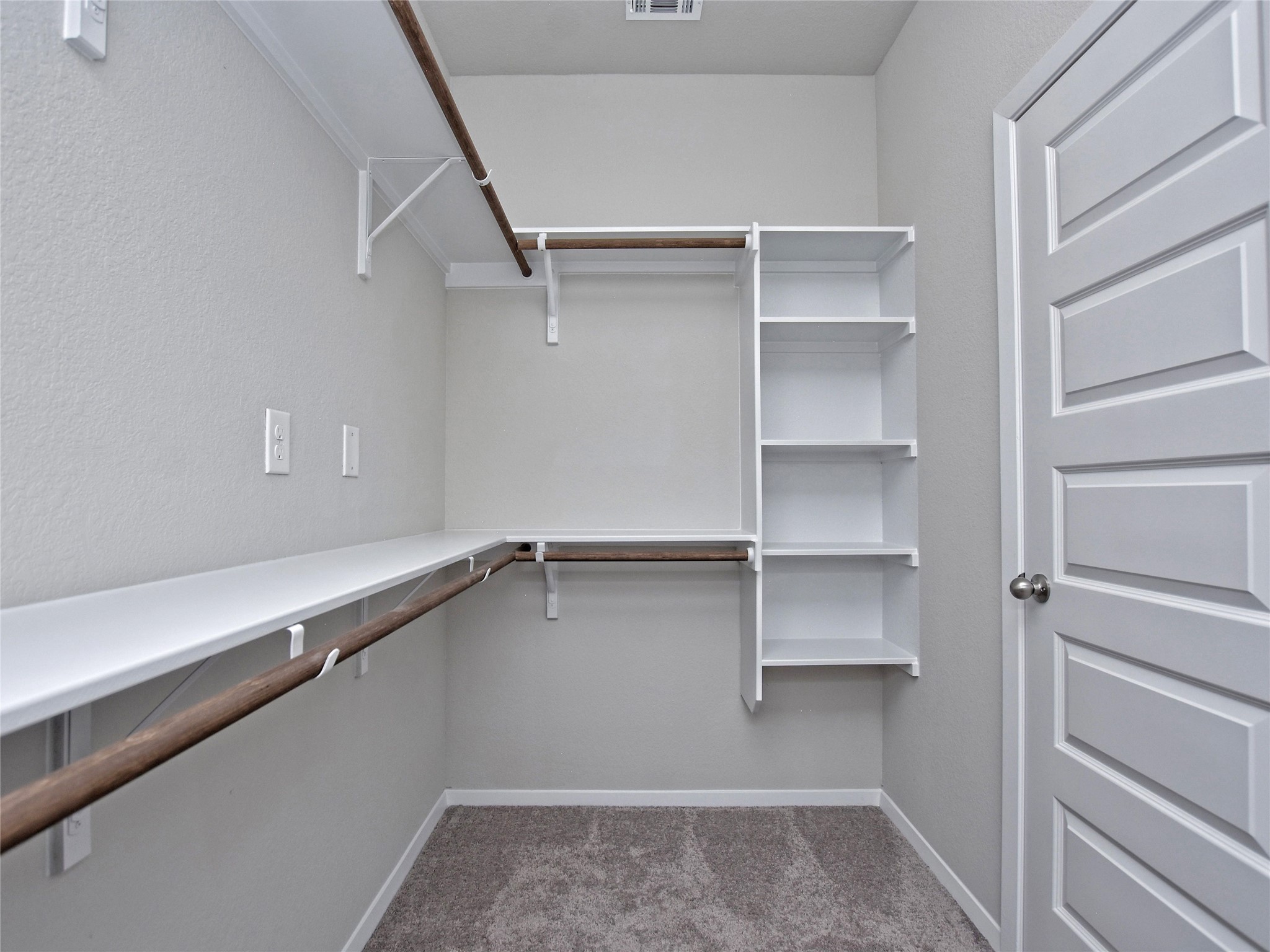 20701 Boggy Ford Road Lago Vista, TX 78645 - Photo 17 of 40 Walk in closet featuring light colored carpet